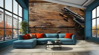 A classic revolver with scattered bullets on an old wooden table, evoking a western theme. Wall mural