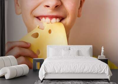 Boy biting a piece of cheese portrait close-up	 Wall mural