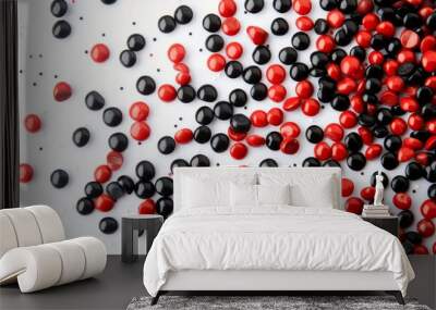 Red And Black Candy Scattered On White Wall mural