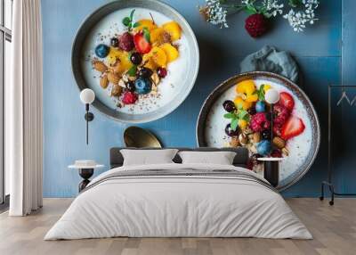 two bowls filled with fruit and nuts next to a spoon Wall mural