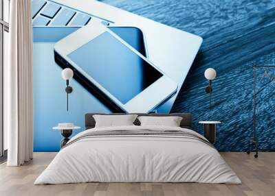 keyboard with phone and tablet pc on wooden desk Wall mural