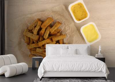 Croutons and two sauces on a wooden table Wall mural