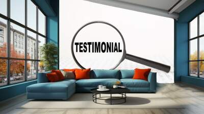 words TESTIMONIAL in a magnifying glass on a white background. business concept Wall mural