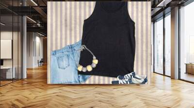 Black tank top mockup fashion clothing still life with jean shorts, blue canvas shoes and costume jewelry on a striped background.  Great for clothing and apparel summer wear. Wall mural