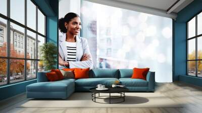 Black woman, arms crossed and thinking with a smile from business consultant work with mockup space. Ideas, female entrepreneur and professional from New York happy from startup by window bokeh Wall mural