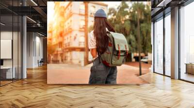 Asian female tourist student on city streets Wall mural