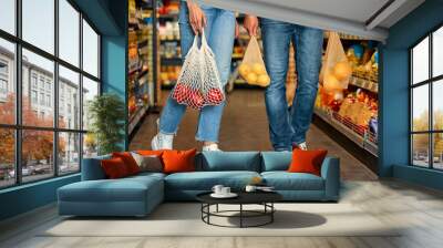 Family buying groceries in supermarket Wall mural