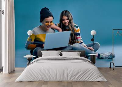 Fashionable boy and cute girl on a blue background Wall mural