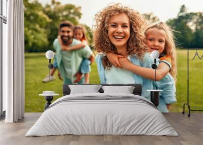 Happy family relaxing in the park Wall mural