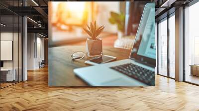 Image of the work environment at home. Freelance. On the table is a laptop, phone and glasses. Wall mural