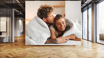 Young couple in love spending time together at home Wall mural