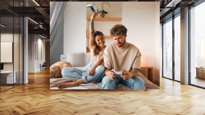 Young couple in love spending time together at home Wall mural