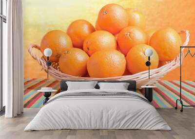 Beautiful ripe oranges on the table and a yellow orange backgrou Wall mural