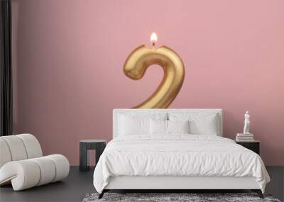 Burning golden birthday candle on pink background, number 2 Wall mural