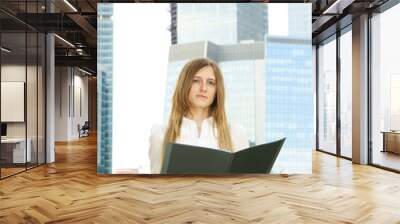 Business woman with folder on city background Wall mural