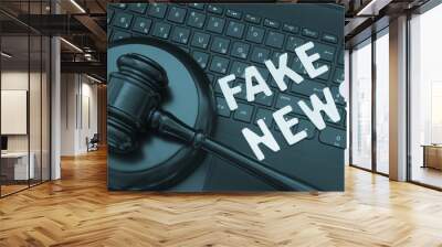 Fake news words and wooden gavel on laptop computer keyboard  Wall mural