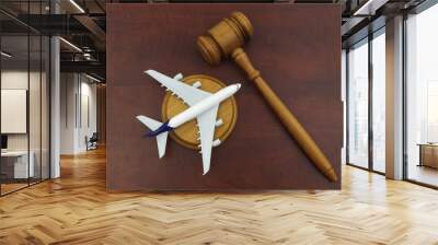 Flight cancellation, aviation law, sue airline company concept. Wooden judge gavel and airplane model on wooden background. Wall mural