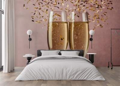 Two champagne glasses toasting with falling confetti on pink background Wall mural