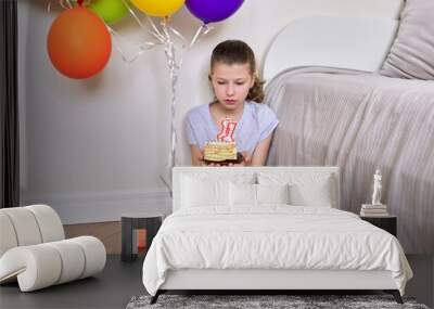 Birthday eleven years old, preteen girl with a small cake and candles 11 Wall mural