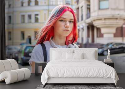 Fashionable teen girl with bright dyed colored hairstyle on city Wall mural