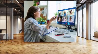 Female teacher working at home, online lesson with group of teenage students Wall mural