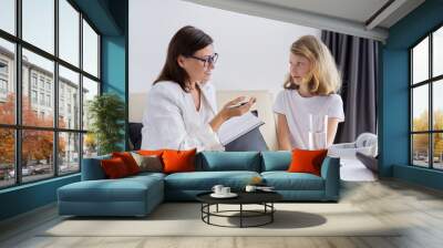 Girl child at session with female psychologist counselor social worker in office Wall mural