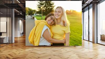 Hugging happy smiling mother and teenage daughter together Wall mural