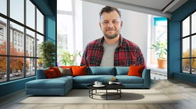 Portrait of 40 years old man, smiling male in plaid casual shirt looking at camera Wall mural