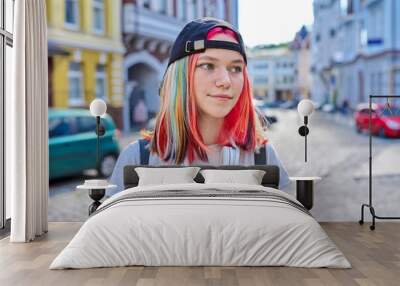 Portrait of fashionable hipster teenage girl with colored dyed hair in black cap Wall mural