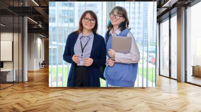 Portrait of middle aged female teacher and girl college student Wall mural