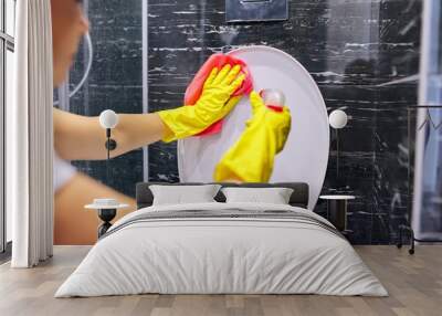 Woman in gloves with detergent washing the toilet close-up Wall mural