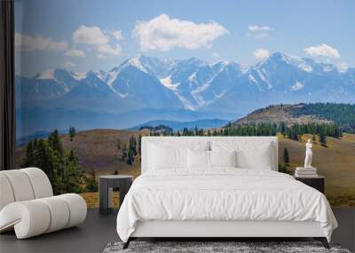 Mountain scenery, snow-capped mountain peaks, sunny day Wall mural