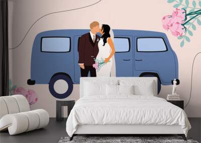 After the wedding, the newlyweds go on a honeymoon trip. Woman in wedding dress, man in tuxedo, retro blue bus Wall mural