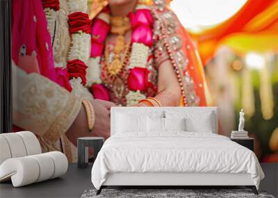 Indian Hindu Couple holding each other hands during their marriage symbolising love and affection. Hands of bride is decorated beautifully by indian mehndi art alongwith jewellery and colorful bangles Wall mural