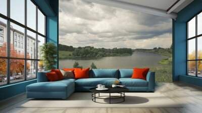 Cloudy summer landscape with river. Wall mural