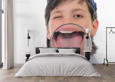 boy looking through a magnifying glass Wall mural