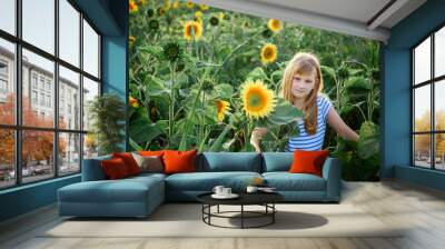 Girl in sunflowers outdoors. Holidays. summer sun Wall mural