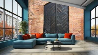 vintage wooden door in a brick wall. Wall mural