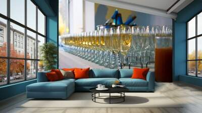 aperitif set with rows of alcohol glasses filled with dry white wine, restaurant catering at a party Wall mural