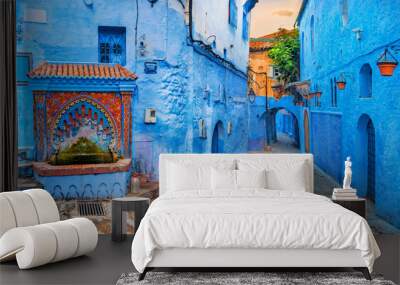 Fountain with drinking water on house coloured wall in blue town Chefchaouen. Morocco, North Africa Wall mural