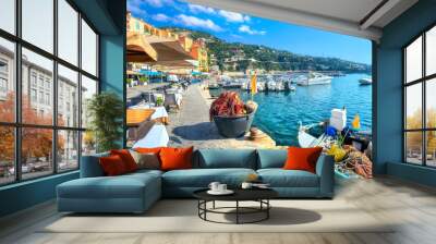 Street scene with cafe and fishing boat in resort town Villefranche-sur-Mer. Cote d'Azur, France Wall mural