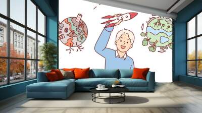 Boy dreams ecological migration, which will allow to leave polluted planet and fly away on rocket. Child thinks about carbon footprint and industrial pollution nature causing ecological disaster Wall mural