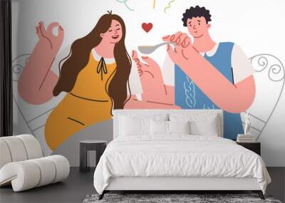 Romantic dinner of man and woman eating spaghetti during date in fashionable italian restaurant. Date of young happy couple of guy feeding girlfriend with spoon as sign of love and care Wall mural