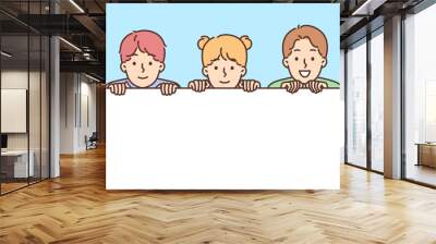 Smiling children holding mockup banner Wall mural