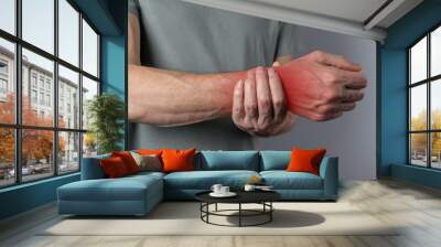 Wrist pain. Man hand closeup holding painful wrist. Health care concept. High quality photo Wall mural