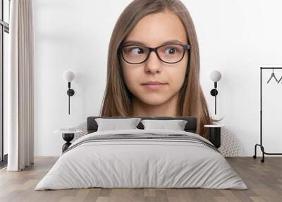 Crazy child making grimace - Silly face. Funny caucasian teen girl in eyeglasses, isolated on white background. Close-up portrait. Wall mural