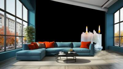 Burning candles on a black background. Wall mural