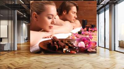 Attractive couple relax at the spa salon. Wall mural