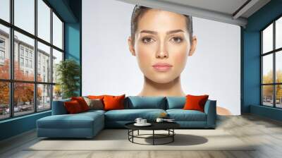 Beautiful face of young caucasian woman with perfect health fresh skin.  Skin care concept. Closeup face of a  white brunette woman looking to the camera. Perfect skin of a caucasian adult girl Wall mural