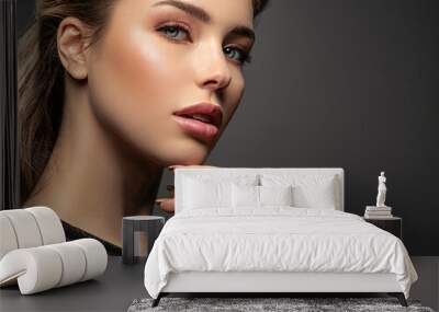 Beautiful face of young  woman with healthy skin. Pretty model caring of face.  Skin care concept.. Wall mural